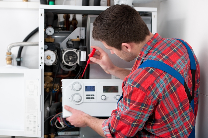 Gas Safe engineer working on a boiler in Thamesmead